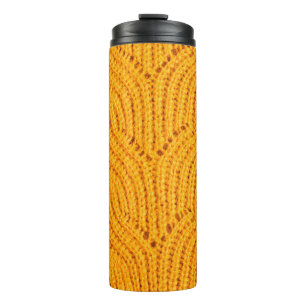 Orange knitted sweater, textured background. thermal tumbler