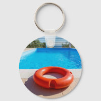 Orange life buoy at blue swimming pool
