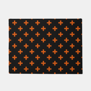 Orange polka crosses on black doormat