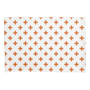 Orange polka crosses on white pillowcase