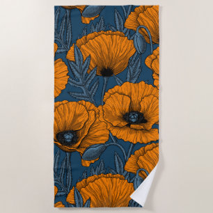 Orange poppies on dark blue beach towel