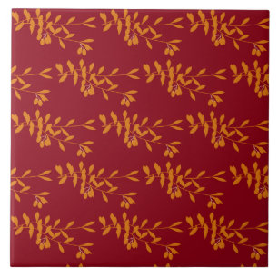 Orange silhouette branch leaves on red ceramic tile