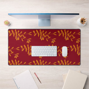 Orange silhouette branch leaves on red desk mat
