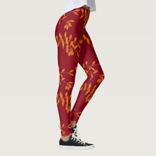 Orange silhouette branch leaves on red leggings