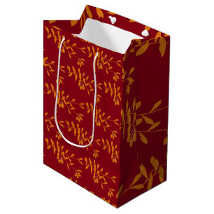 Orange silhouette branch leaves on red medium gift bag