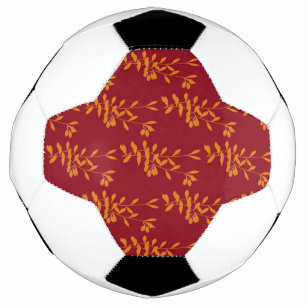 Orange silhouette branch leaves on red soccer ball