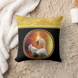 Orange sunset behind a White Swan with gold foil Cushion