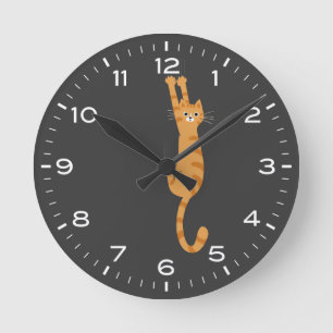 Orange Tabby Cat Hanging On Funny Round Clock