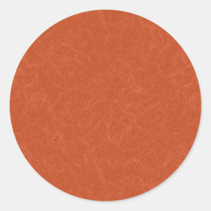 Orange textured surface with swirling pattern classic round sticker