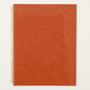 Orange textured surface with swirling pattern planner