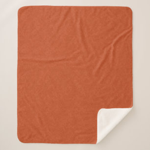 Orange textured surface with swirling pattern sherpa blanket