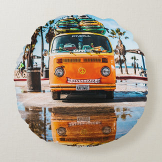 Orange van with surfboard on top round cushion