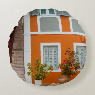 ORANGE WHITE AND GRAY CONCRETE BUILDING ROUND CUSHION