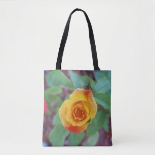 Orange yellow rose with morning dew on a tote bag