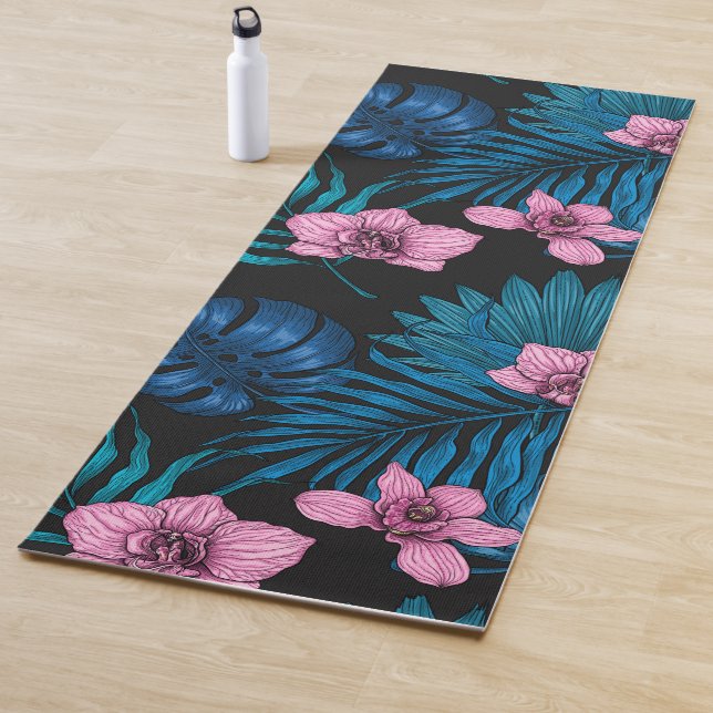 Orchids and palm leaves, pink and blue on black yoga mat (In Situ)