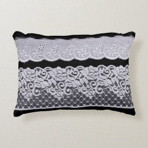 Ornamental white lace, isolated black background. decorative cushion