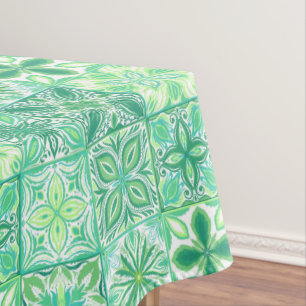 Ornate tiles in green and white tablecloth