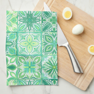 Ornate tiles in green and white tea towel