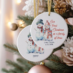 Our First Christmas as Family of Three Snowman Ceramic Ornament<br><div class="desc">Christmas ornament keepsake for your first christmas as a family of three. The design features a cute family of 3 snowmen - mummy, daddy and baby - dressed in hats and scarves. The wording reads "Our First Christmas as a family of three". You can personalise the design with your names...</div>