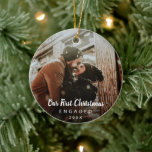 Our First Christmas Engaged Chalk Script Photo Ceramic Ornament<br><div class="desc">Did you get engaged this year? Add a memory to your tree with this modern keepsake ornament featuring a simple yet elegant design with the message "Our First Christmas Engaged" in white chalk script along with the year, over your favourite photo. Add the same photo to both sides or a...</div>