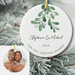 Our First Christmas Engaged Mistletoe Photo Ceramic Ornament<br><div class="desc">Celebrate your first Christmas as an engaged couple with this stylish photo ceramic ornament. 
It is decorated with watercolor mistletoe and elegant script typography.
Easily customisable with your names,  date,  and photo.
Use the Design Tool to change the text size,  style,  or colour.
Original Watercolor © Michele Davies.</div>