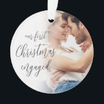 Our First Christmas Engaged Photo Names Script Ornament<br><div class="desc">Our First Christmas Engaged Custom Photo Names Script. A fully customisable design especially to celebrate the happy couple’s first Christmas after their engagement and memento for the tree in Christmasses to come.. A beautiful calligraphy script for the text on the front and names on the back. Easily personalise with your...</div>