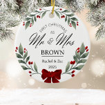 Our First Christmas Mr and Mrs Greenery Watercolor Ceramic Ornament<br><div class="desc">Celebrate your first holiday as a married couple with our Mr. and Mrs. Our First Christmas Ornament. Set against a white background, this elegant ornament features beautiful botanical holly berries, delicate greenery, and charming watercolor florals. Personalise it with your names and wedding date to create a timeless keepsake that will...</div>