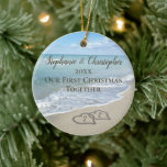 Our First Christmas Together Beach Hearts in Sand Ceramic Ornament<br><div class="desc">Remember a beach wedding or honeymoon with this keepsake wedding ornament. First Christmas together with two interlocking beach wedding hearts drawn in the sand makes an elegant tropical ocean coastal nautical theme wedding,  matching set of items. Pretty turquoise water waves crashing on the shore and pastel blue sky.</div>