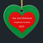 Our Second Christmas Together Cute Red Heart 2023 Ceramic Ornament<br><div class="desc">Personalised names and printed with cute red heart design in solid green background. Feel free to customise by adding your own texts,  names or photos. You can add your photo on the back side of the ornament easily!
The colour of the background can also be changed as you want.</div>