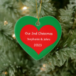 Our Second Christmas Together Cute Red Heart 2023  Ceramic Ornament<br><div class="desc">Personalised names and printed with cute red heart design in solid green background. Feel free to customise by adding your own texts,  names or photos. You can add your photo on the back side of the ornament easily!
The colour of the background can also be changed as you want.</div>