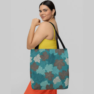 Overlapping maple leaves in shades of teal, brown tote bag