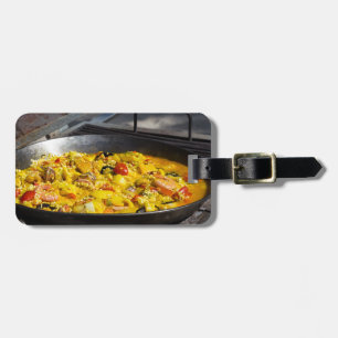 Paella is cooked on a grill luggage tag