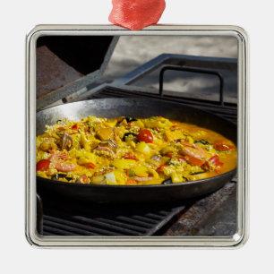 Paella is cooked on a grill metal ornament