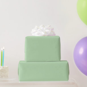 pale sage-green wallpaper sheet, partly rolled wrapping paper