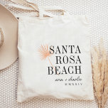 Palm Frond Destination Wedding Welcome Tote Bag<br><div class="desc">Welcome guests to your destination wedding with these chic and modern personalised tote bags. Design features a light tropical peach palm frond illustration with your wedding destination aligned at the right (shown with Santa Rosa Beach) in classic serif lettering. Add your names beneath in handwritten cursive script, as well as...</div>
