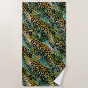Palm leaves on a leopard background. beach towel