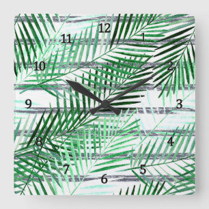 Palm leaves on a striped black and white backgroun square wall clock
