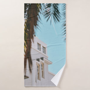 Palm tree near white concrete building bath towel