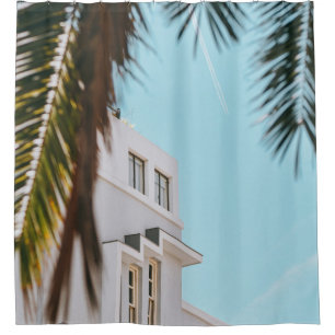 Palm tree near white concrete building shower curtain