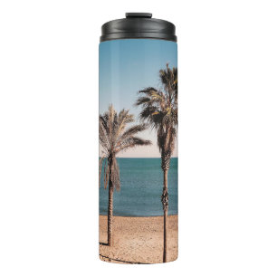 Palm tree on beach shore in the morning thermal tumbler