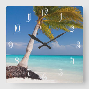 Palm tree on the beautiful white sand beach square wall clock