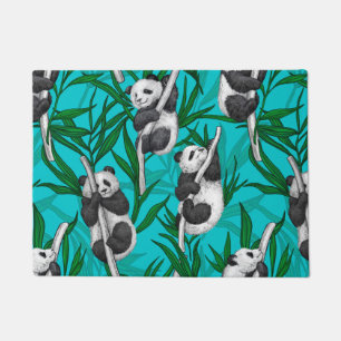 Panda cubs on turquoise doormat