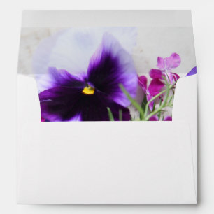 Pansies and lobelia on old handwriting envelope