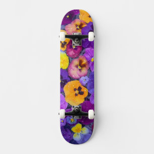 Pansy flowers floating in bird bath with dew skateboard