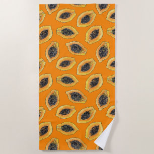 Papaya slices on orange beach towel