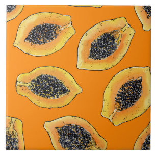 Papaya slices on orange ceramic tile
