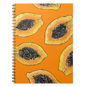 Papaya slices on orange notebook