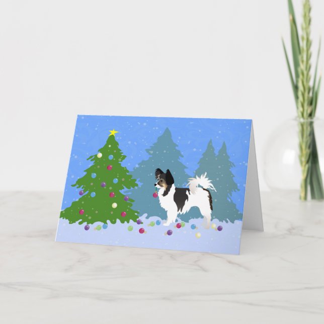 Papillon Dog Decorating Christmas Tree in Forest Holiday Card (Front)