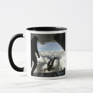 Pararescuemen jump out the back of a C-130 Mug