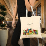 Parrots birds name script tote bag<br><div class="desc">Tropical birds,  parrots in blue,  yellow and red sitting on green palm leaves.  Decorated with tropical flowers. No background colour. Template for a name,  black hand lettered style script.</div>